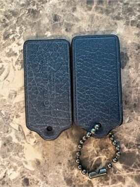 COACH set of 2 metallic navy bag tags
